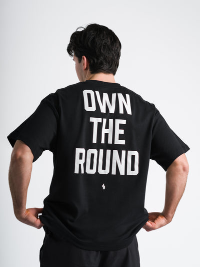 Male model wearing black One Bout OWN THE ROUND Oversized T-Shirt back view